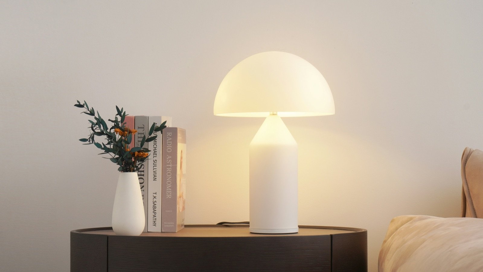A warm, glowing white table lamp